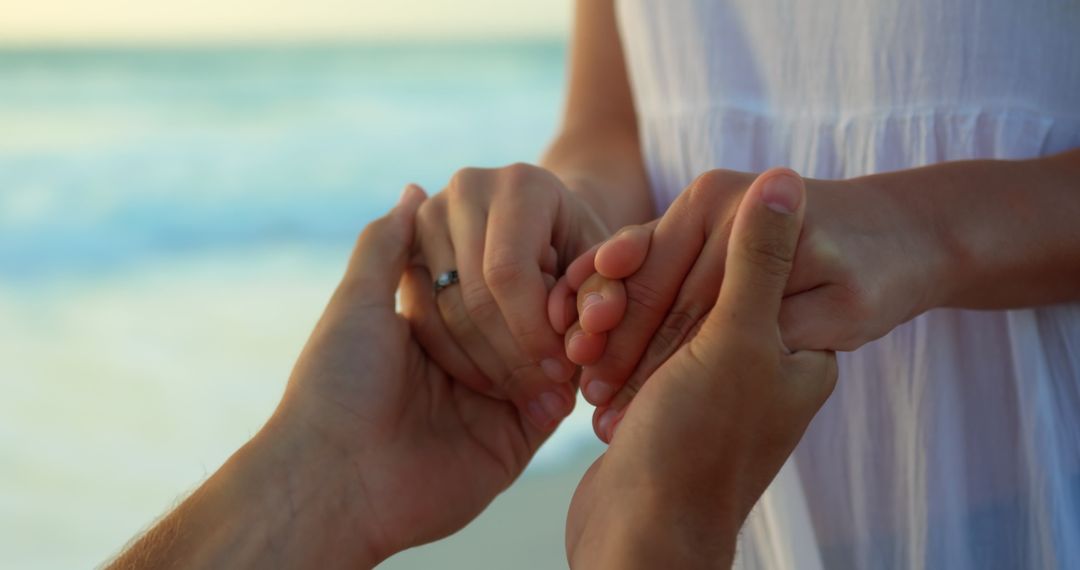 Man Proposing with Ring at Seaside during Golden Hour