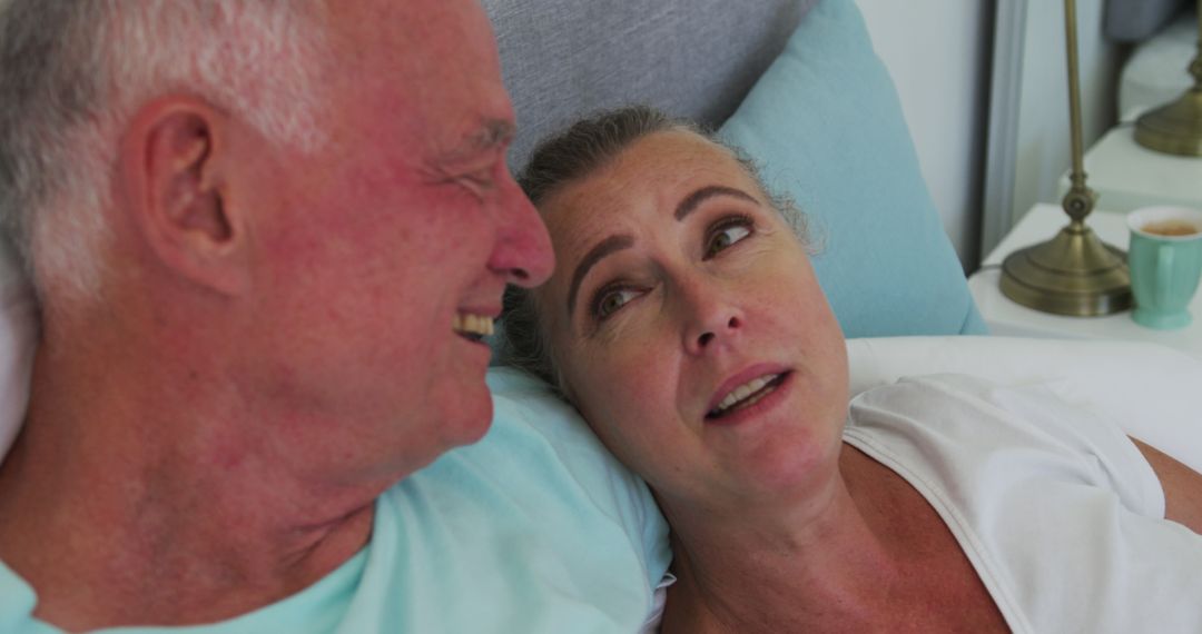 Senior Couple Sharing Moments in Bed at Home
