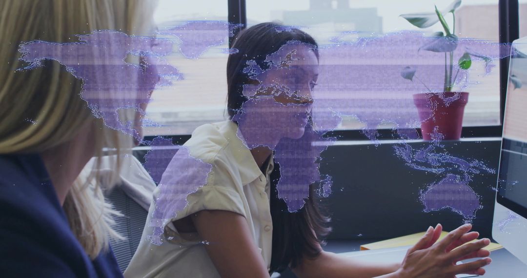 Businesswomen Collaborating with Holographic World Map Overlay for Global Team Strategy