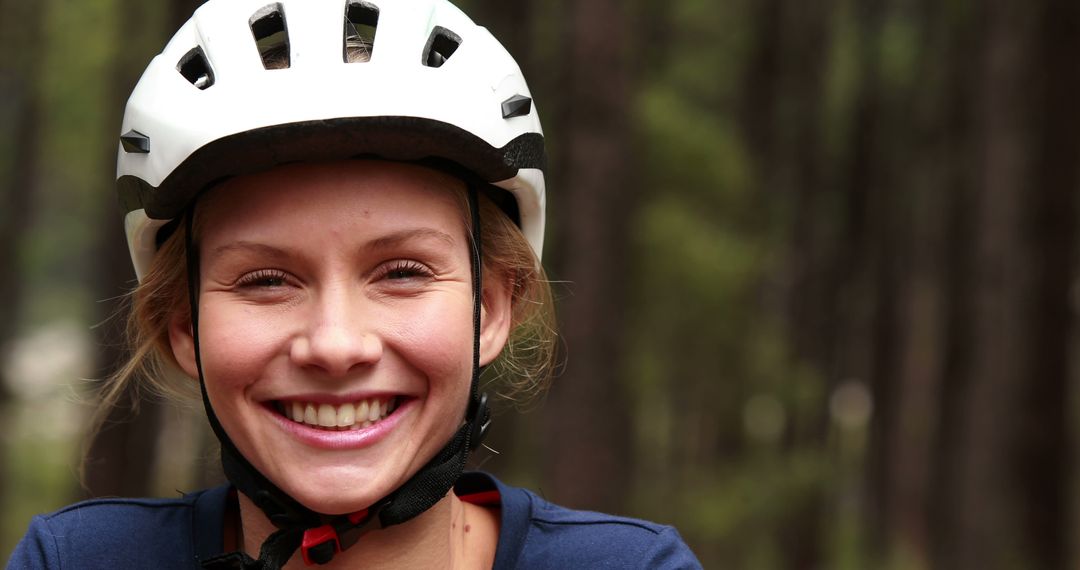 Smiling Woman Wearing Bike Helmet in Forest - Free Images, Stock Photos and Pictures on Pikwizard.com