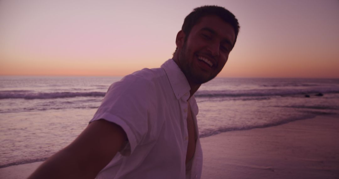 Man Smiling at Sunset on Beach - Free Images, Stock Photos and Pictures on Pikwizard.com