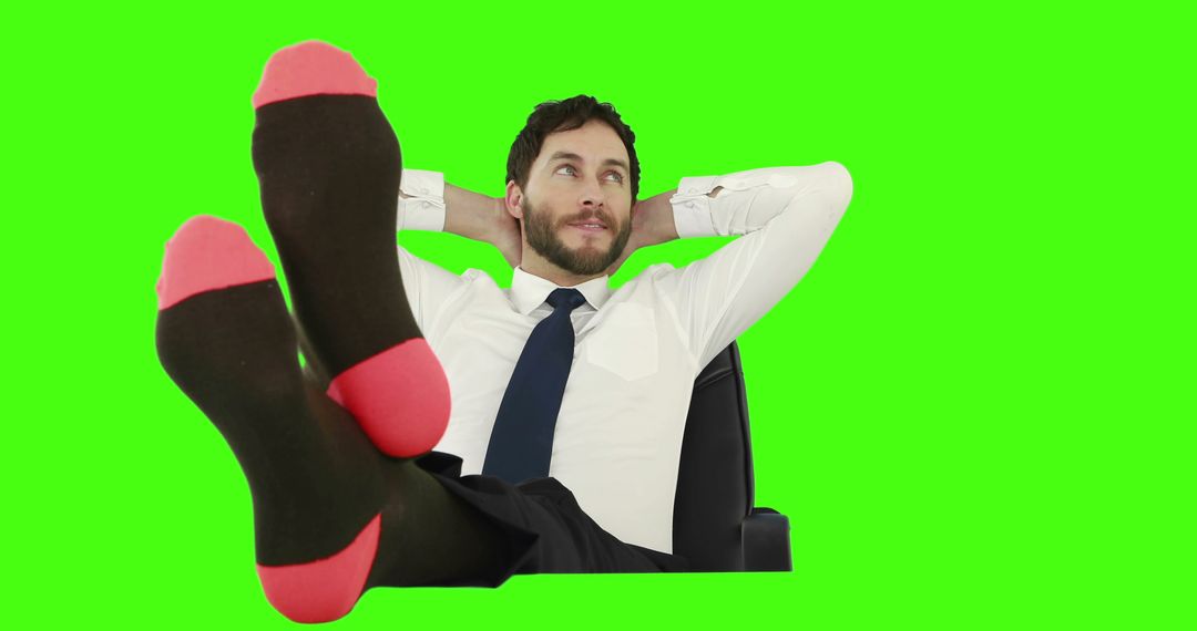 Relaxed Businessman Leaning Back with Feet Up Against Green Background - Free Images, Stock Photos and Pictures on Pikwizard.com