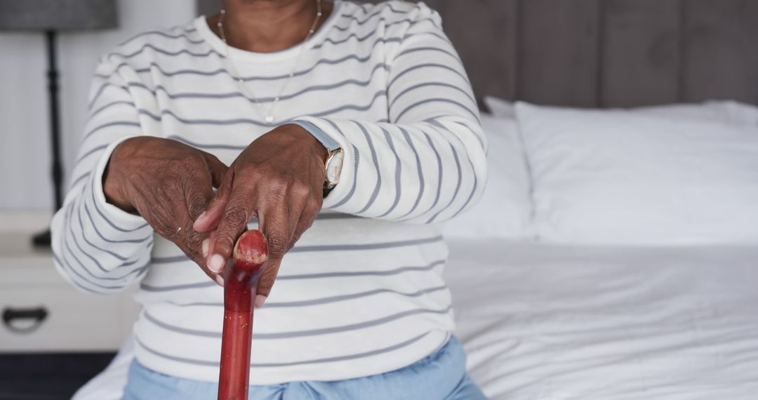 Elderly Person Holding Cane in Bedroom - Free Images, Stock Photos and Pictures on Pikwizard.com