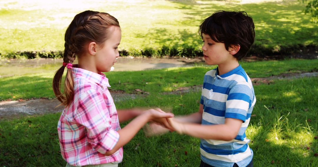 Children Playing Hand Clapping Game Outdoors in Park - Free Images, Stock Photos and Pictures on Pikwizard.com