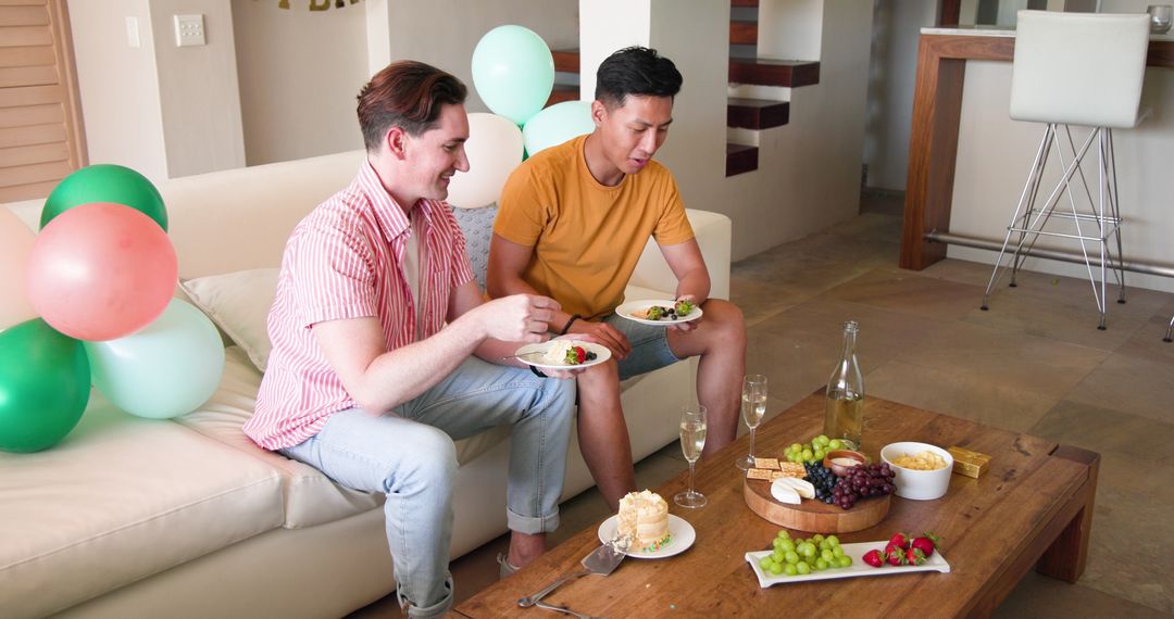 Couple Enjoying Relaxed Home Celebration with Snacks and Drinks