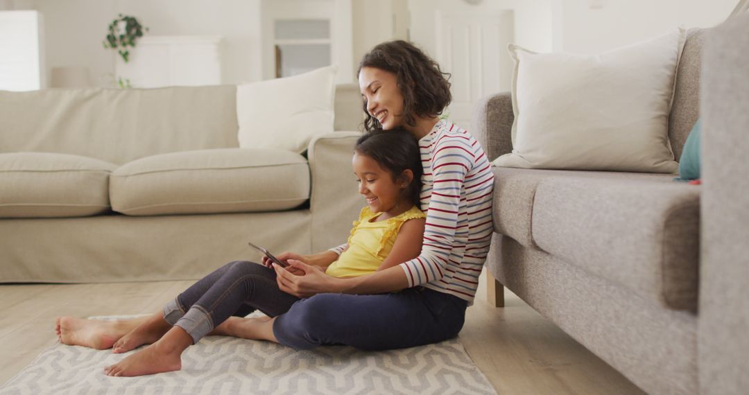 Happy Mother and Daughter Using Tablet at Home Together