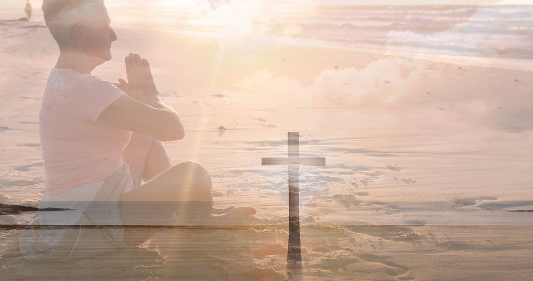 Senior Woman Praying on Beach with Crucifix Overlay Symbolizing Faith