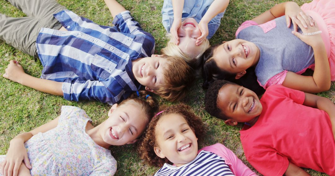 Diverse Group of Happy Children Lying on Grass Together - Free Images, Stock Photos and Pictures on Pikwizard.com