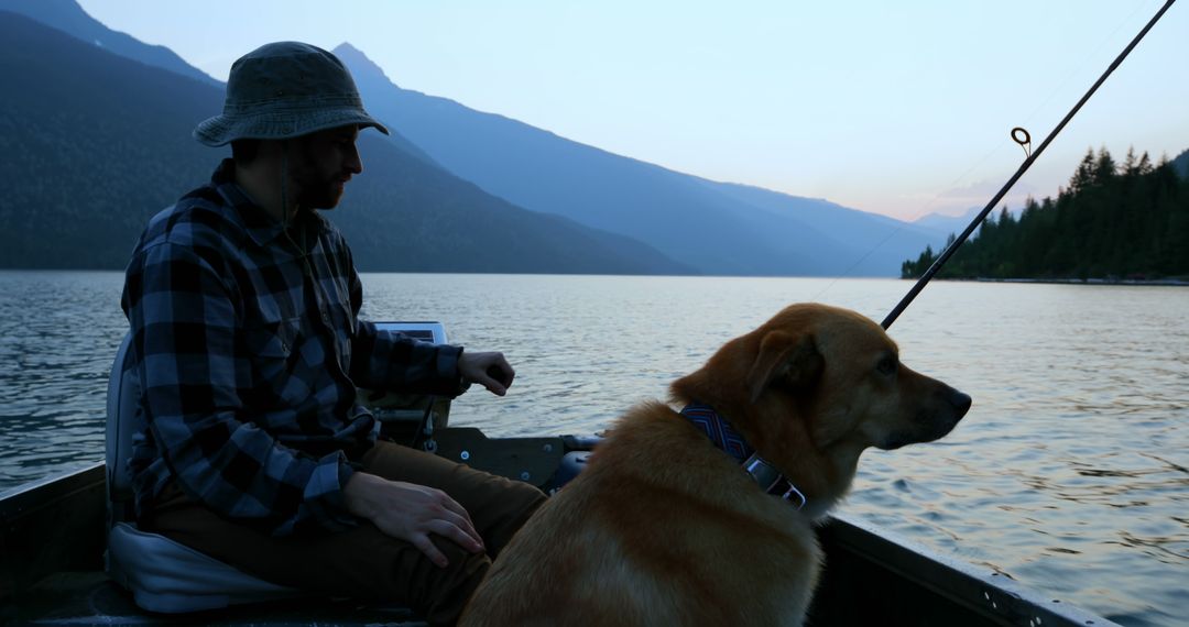 Man Fishing on Lake with Dog at Dusk - Free Images, Stock Photos and Pictures on Pikwizard.com