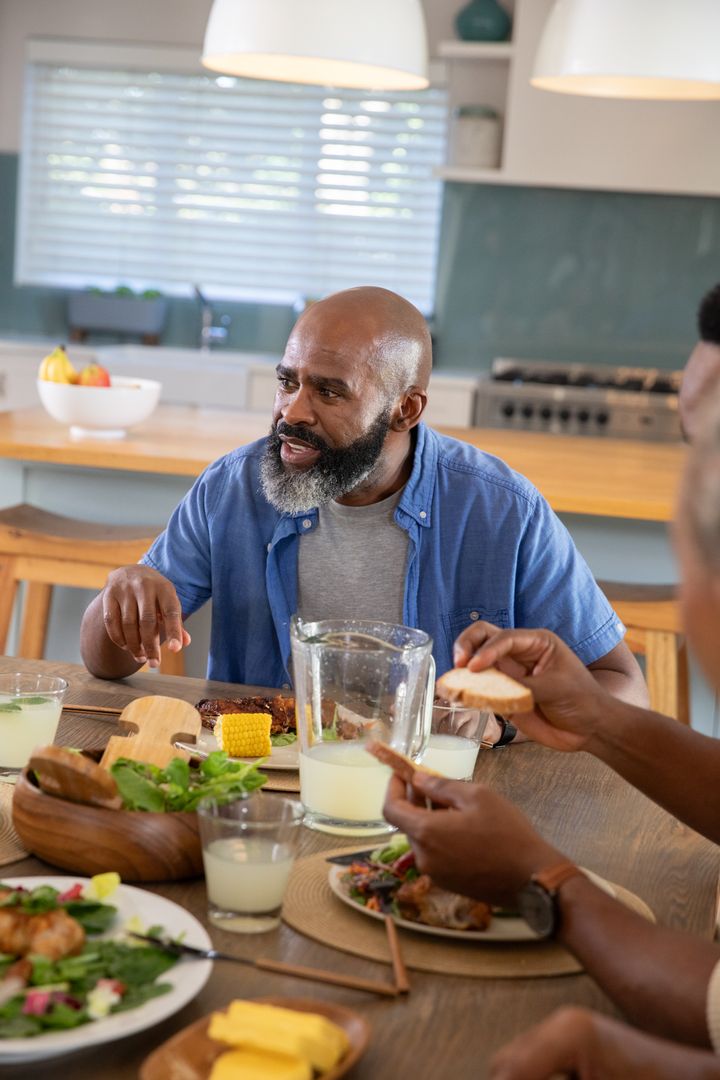 Friends Enjoying a Rustic Meal Together in Cozy Home Setting
