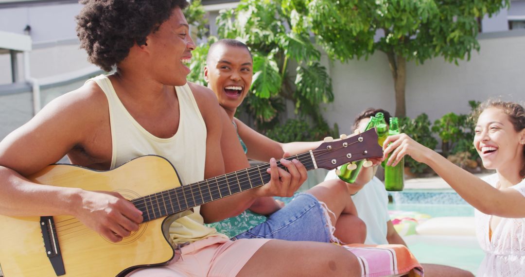 Friends Enjoying Poolside Gathering with Music and Drinks