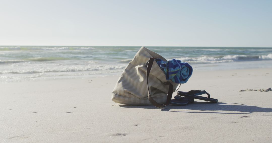 Image of bag with beach equipment lying on sand on beach - Free Images, Stock Photos and Pictures on Pikwizard.com