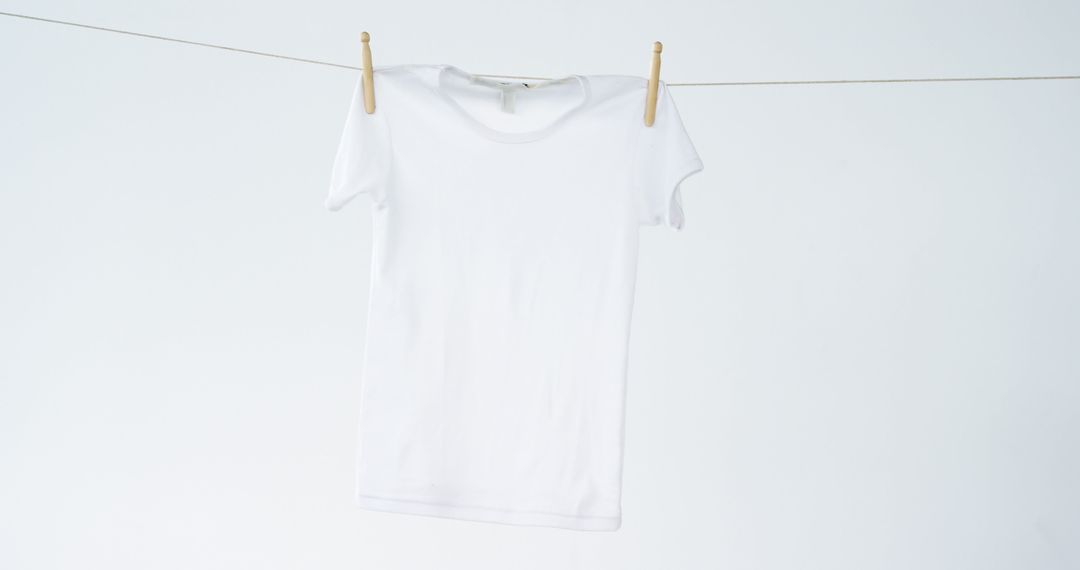 Blank White T-Shirt Hanging on Clothesline Isolated on White - Free Images, Stock Photos and Pictures on Pikwizard.com