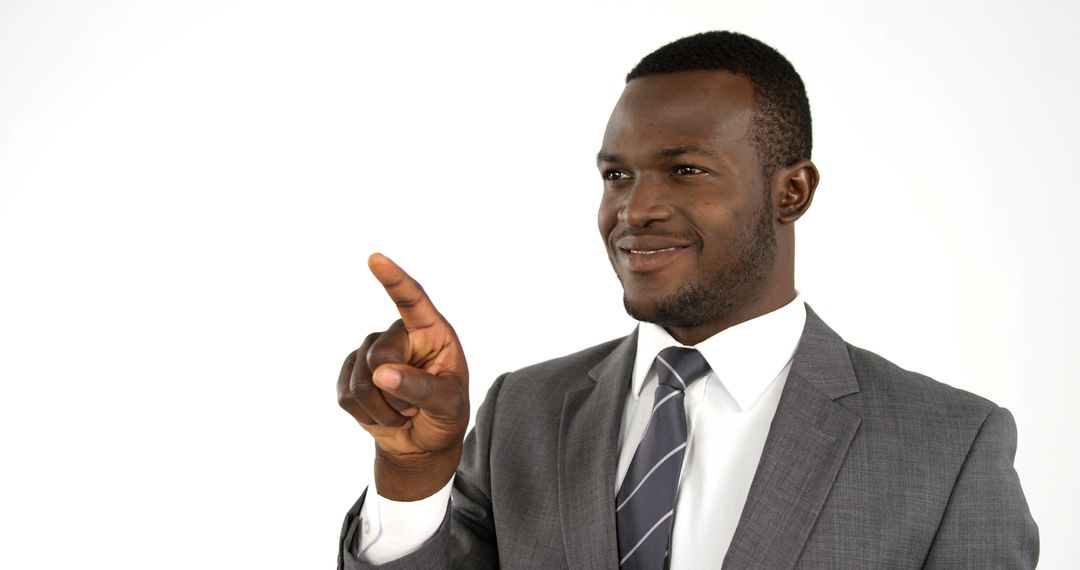 African American businessman in a suit is pointing towards something, with copy space - Free Images, Stock Photos and Pictures on Pikwizard.com
