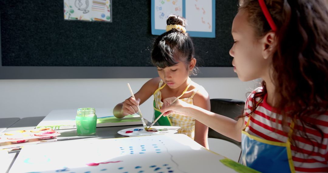Two Girls Collaborating on Art Project in Classroom Setting