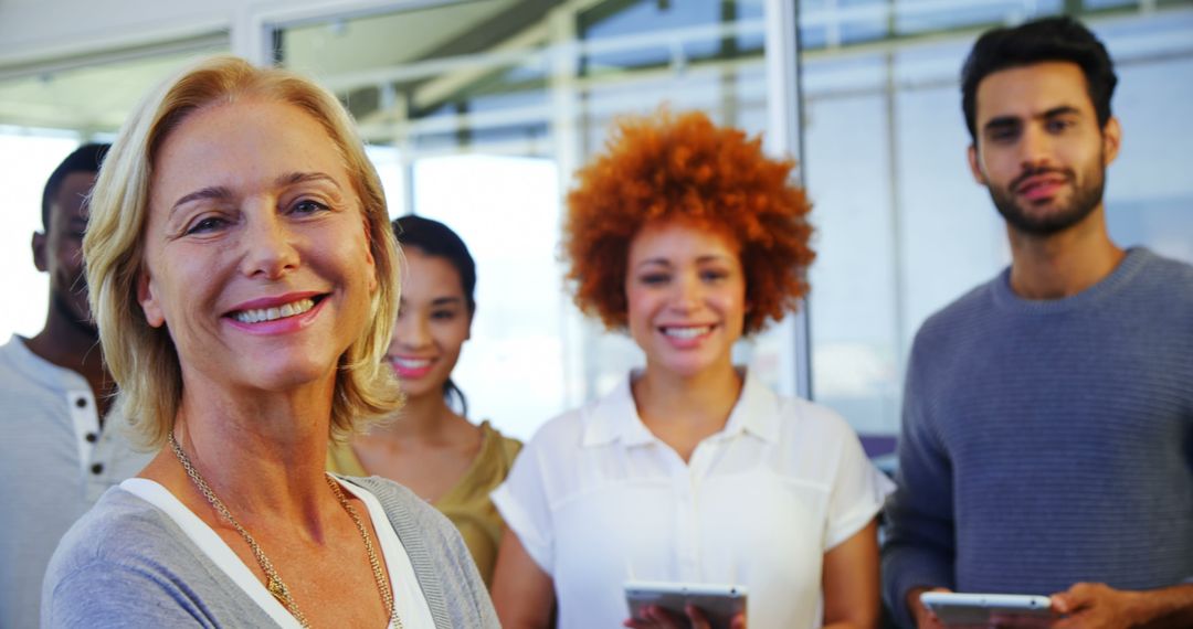 Diverse Group of Professionals Smiling in Modern Office - Free Images, Stock Photos and Pictures on Pikwizard.com