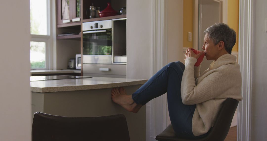 Senior Woman Enjoying Morning Coffee in Modern Kitchen - Free Images, Stock Photos and Pictures on Pikwizard.com