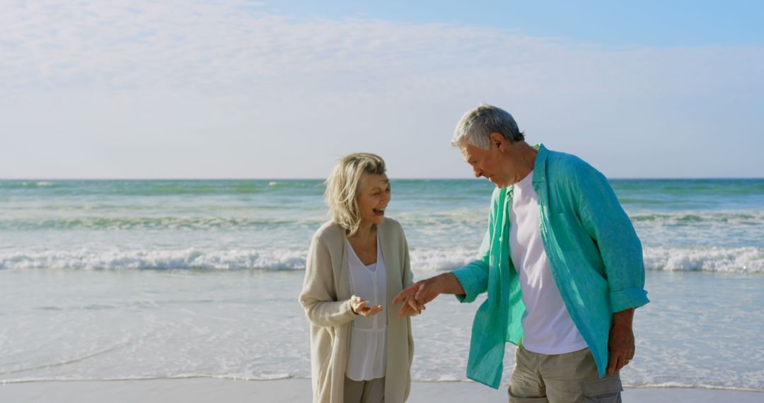 Smiling Senior Couple Enjoying Leisurely Walk by the Beach