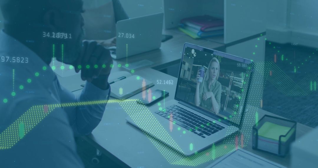 Office Workspace Featuring Virtual Meeting with Financial Data Overlay
