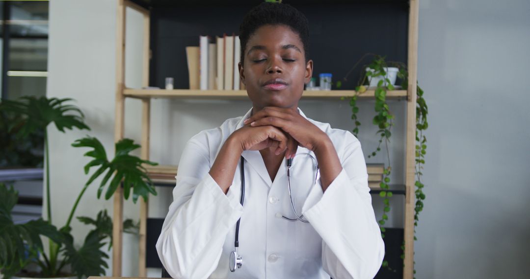 Calm Female Doctor Meditating in Office with Closed Eyes - Free Images, Stock Photos and Pictures on Pikwizard.com