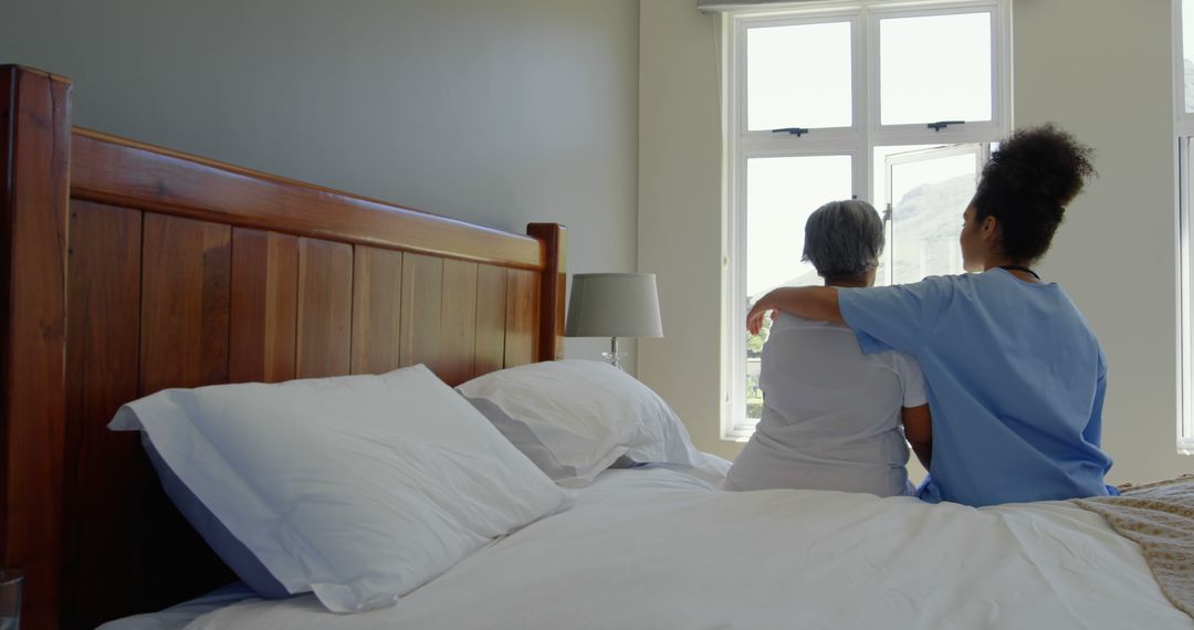 Nurse Comforting Senior Woman on Bed in Calm Bedroom - Free Images, Stock Photos and Pictures on Pikwizard.com