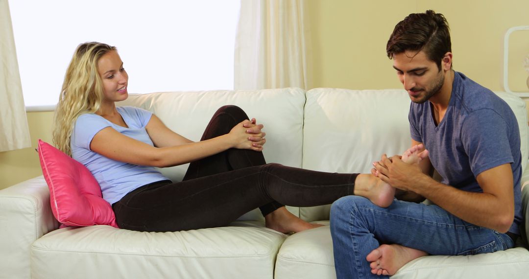 Boyfriend Giving Foot Massage to Happy Girlfriend