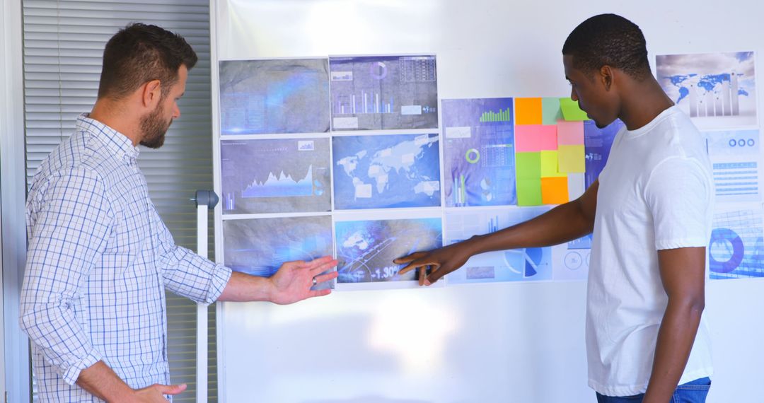 Young Professionals Analyzing Business Graphs in Modern Office