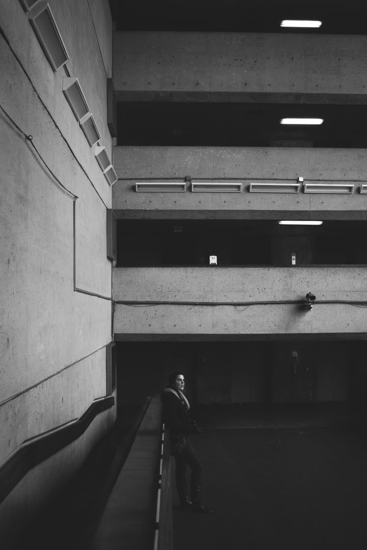 Lonely Man Standing In Modern Concrete Architecture Building - Free Images, Stock Photos and Pictures on Pikwizard.com