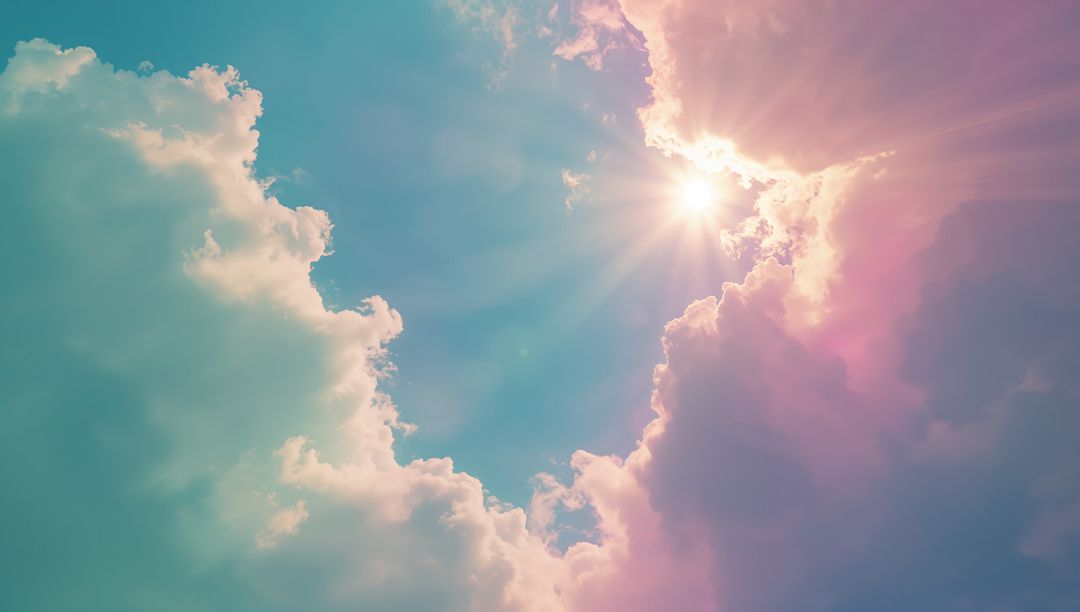 Sunbeams Illuminating Pastel Cumulus Clouds in Vibrant Sky
