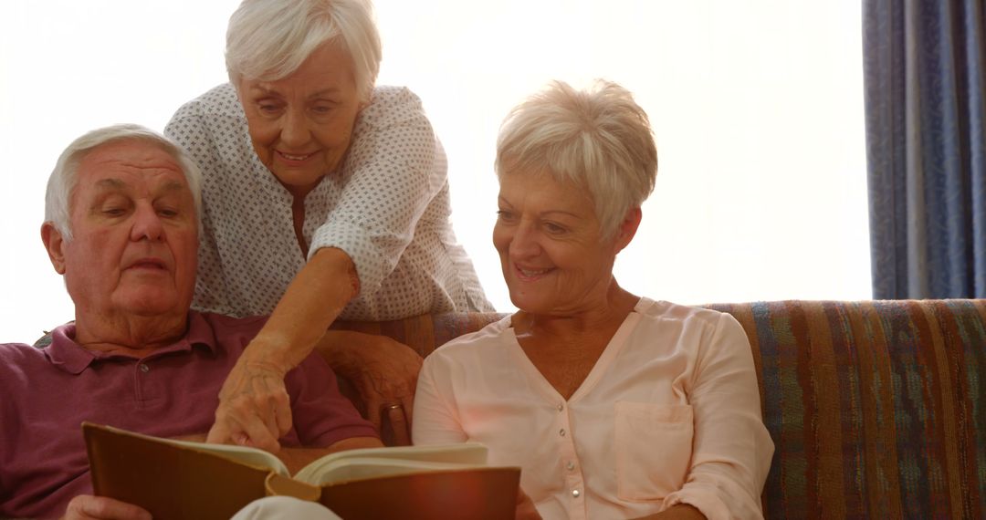 Senior Friends Reading Book and Laughing Together at Home - Free Images, Stock Photos and Pictures on Pikwizard.com