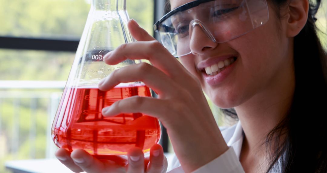 Scientist Holding Red Chemical Solution in Laboratory Flask - Free Images, Stock Photos and Pictures on Pikwizard.com