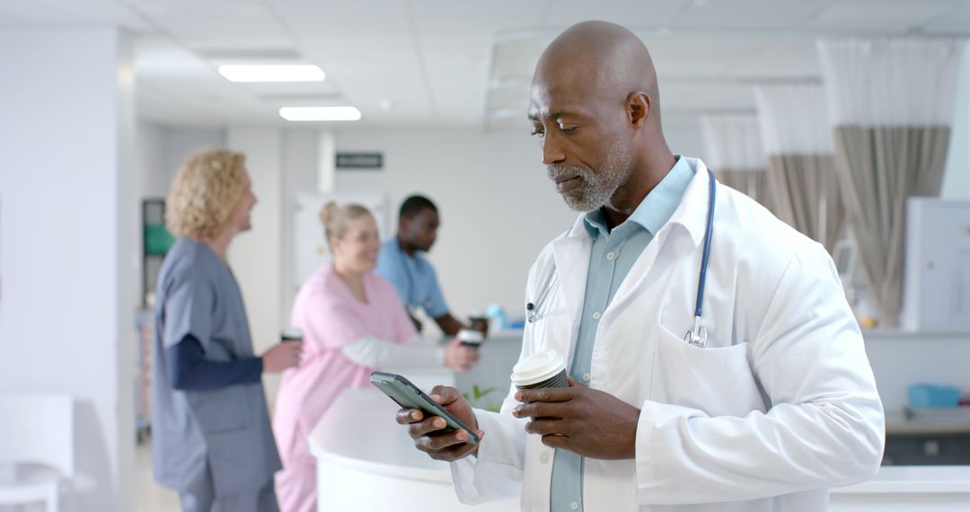 Focused Doctor Using Smartphone in Hospital Hall - Free Images, Stock Photos and Pictures on Pikwizard.com