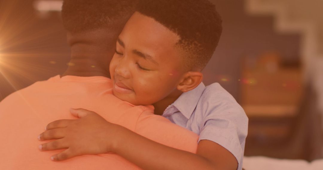 Joyful African American Father and Son Embrace at Home