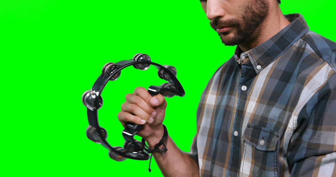 Man Playing Tambourine on Green Screen Background - Free Images, Stock Photos and Pictures on Pikwizard.com