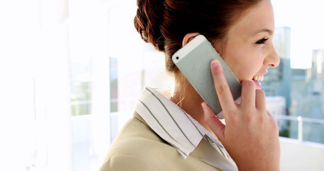 Businesswoman Smiling While Talking on Smartphone - Free Images, Stock Photos and Pictures on Pikwizard.com