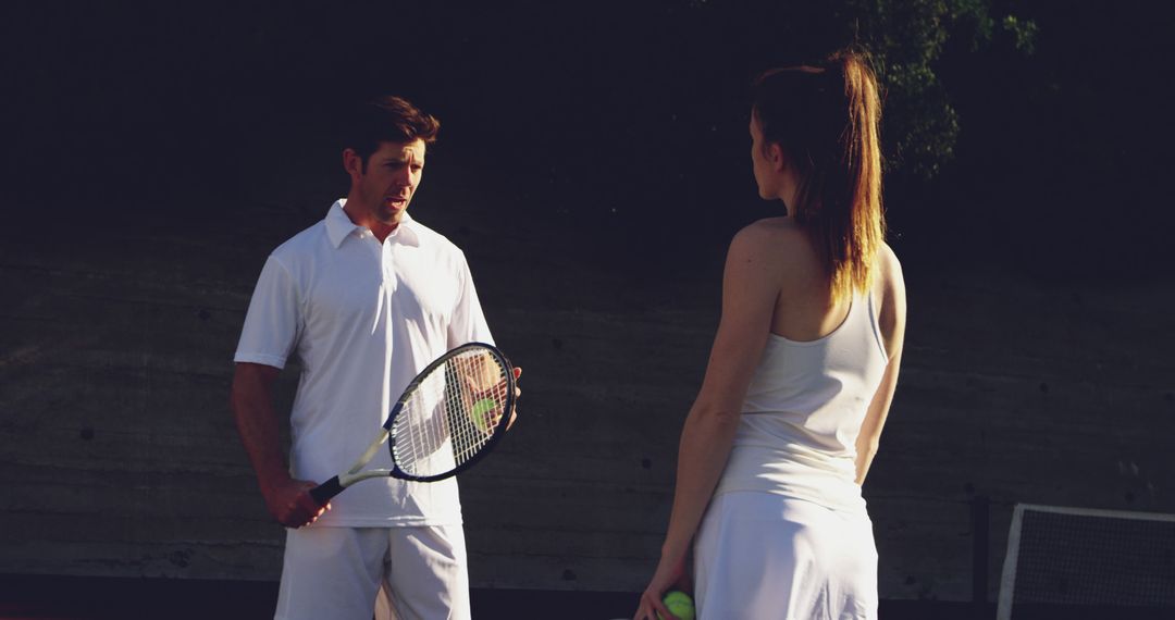 Tennis Coach Giving Instructions to Young Woman on Court - Free Images, Stock Photos and Pictures on Pikwizard.com