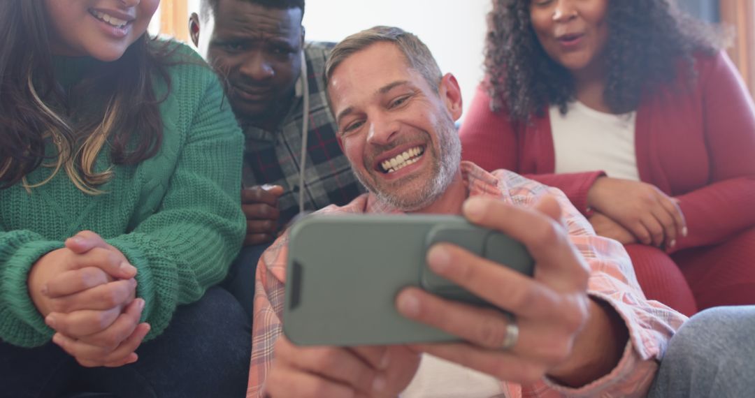 Group of Friends Laughing Together While Sharing a Mobile - Free Images, Stock Photos and Pictures on Pikwizard.com