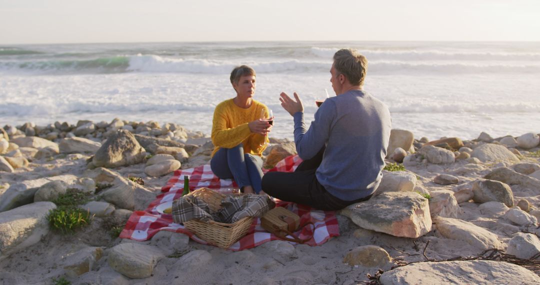 Elderly couple enjoying seaside picnic on a sunny day - Free Images, Stock Photos and Pictures on Pikwizard.com