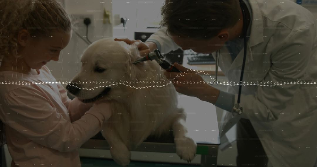 Veterinarian examining golden retriever ear while child comforting dog on exam table