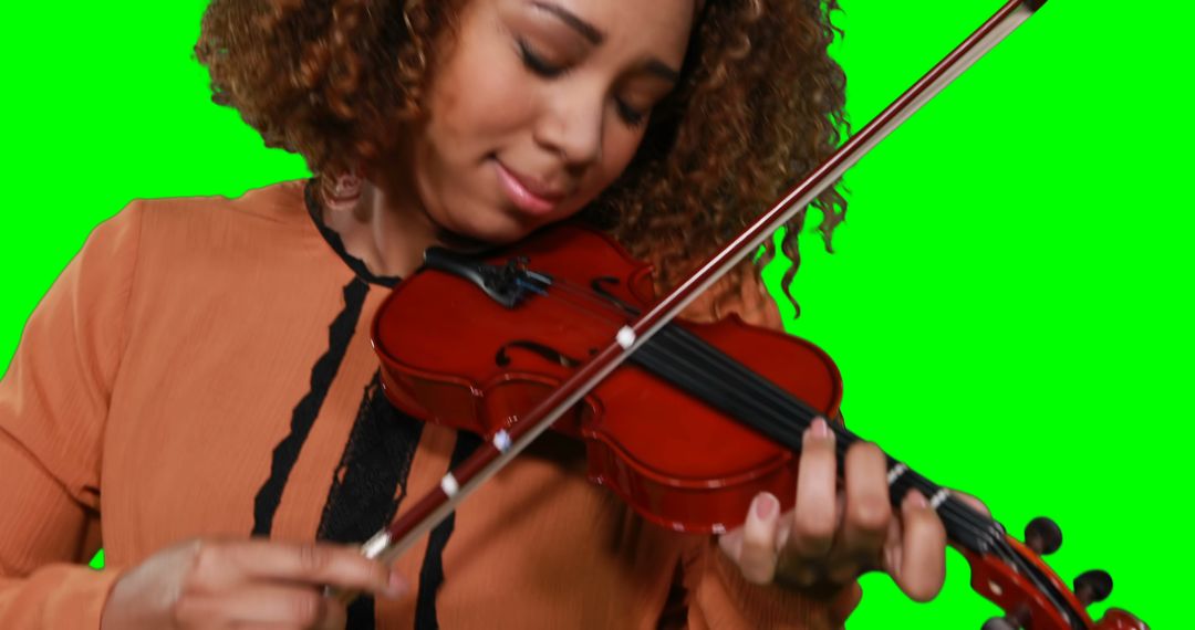 Close-up of female musician playing violin against green screen - Free Images, Stock Photos and Pictures on Pikwizard.com