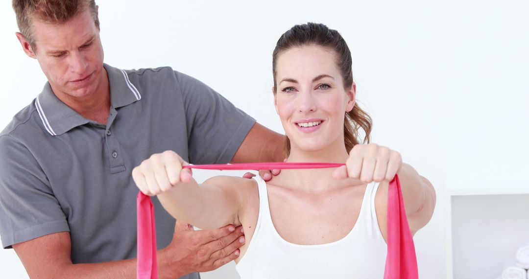 Physical Therapist Assisting Woman with Resistance Band Exercise - Free Images, Stock Photos and Pictures on Pikwizard.com