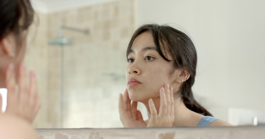 Woman Inspecting Skin in Bathroom for Skincare Routine