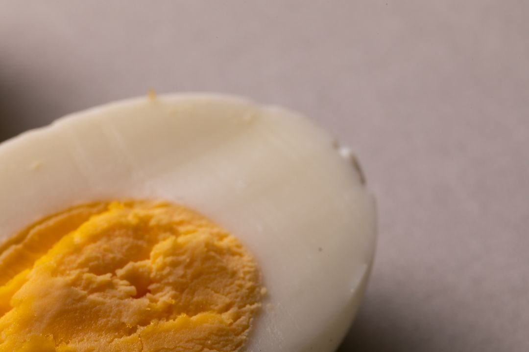 Close-Up of Halved Boiled Egg on White Background - Free Images, Stock Photos and Pictures on Pikwizard.com