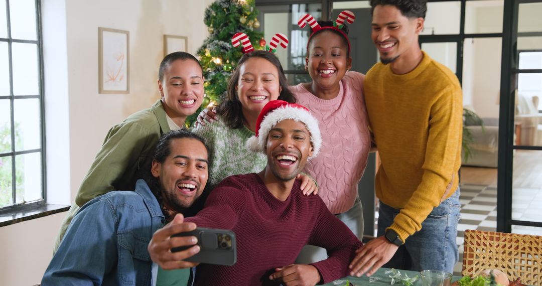 Diverse Friends Taking Christmas Selfie Near Decorated Tree