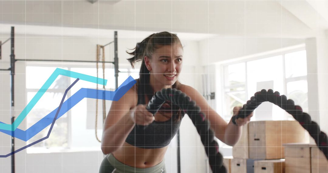 Woman Exercising with Battle Ropes in Gym with Data Graph Overlay