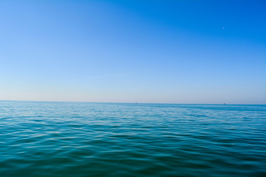 Calm Ocean with Clear Blue Sky Horizon - Free Images, Stock Photos and Pictures on Pikwizard.com