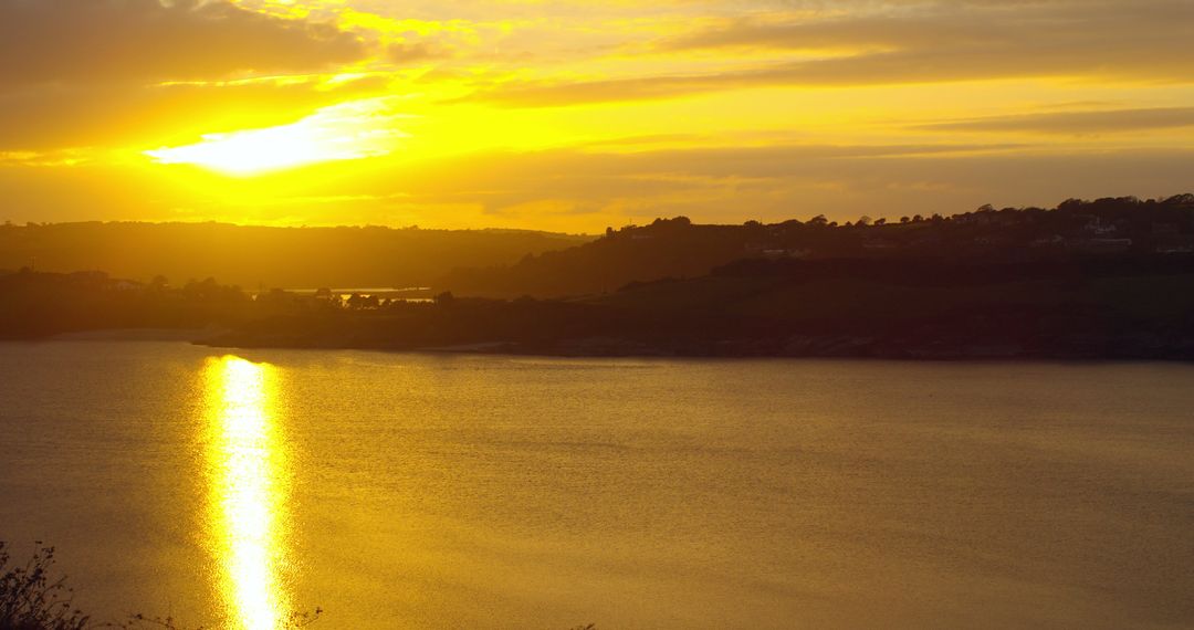 Breathtaking Sunset over Calm Lake with Glowing Sky - Free Images, Stock Photos and Pictures on Pikwizard.com