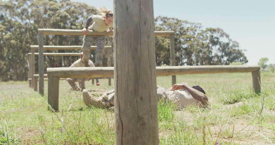 Soldiers Navigating Obstacle Course in Sunlit Boot Camp