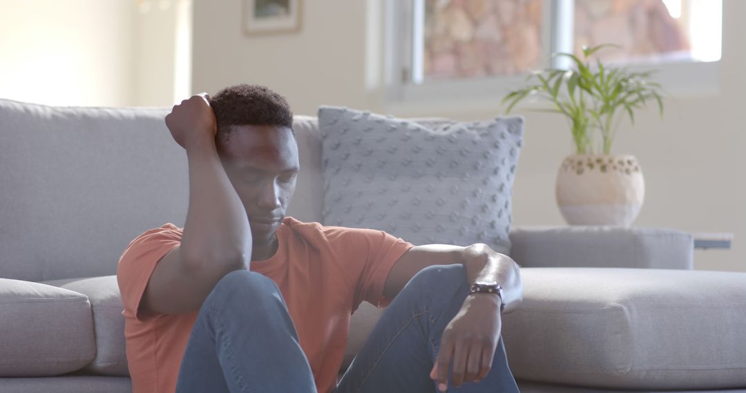 Man Sitting on Floor in Living Room Looking Stressed and Anxious - Free Images, Stock Photos and Pictures on Pikwizard.com