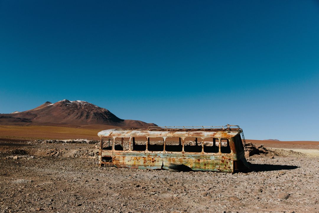 Abandoned Rusted Bus in Remote Desert Landscape